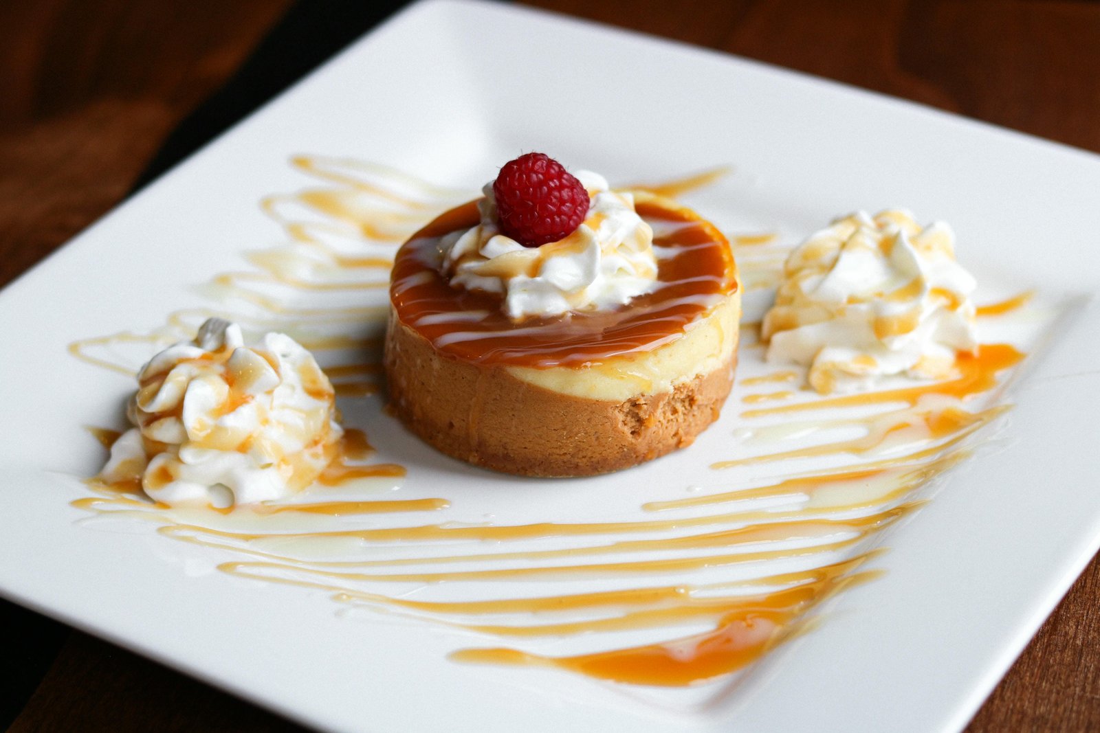Salted caramel cheesecake with caramel sauce, raspberry and whipped cream at Tequila Fuego