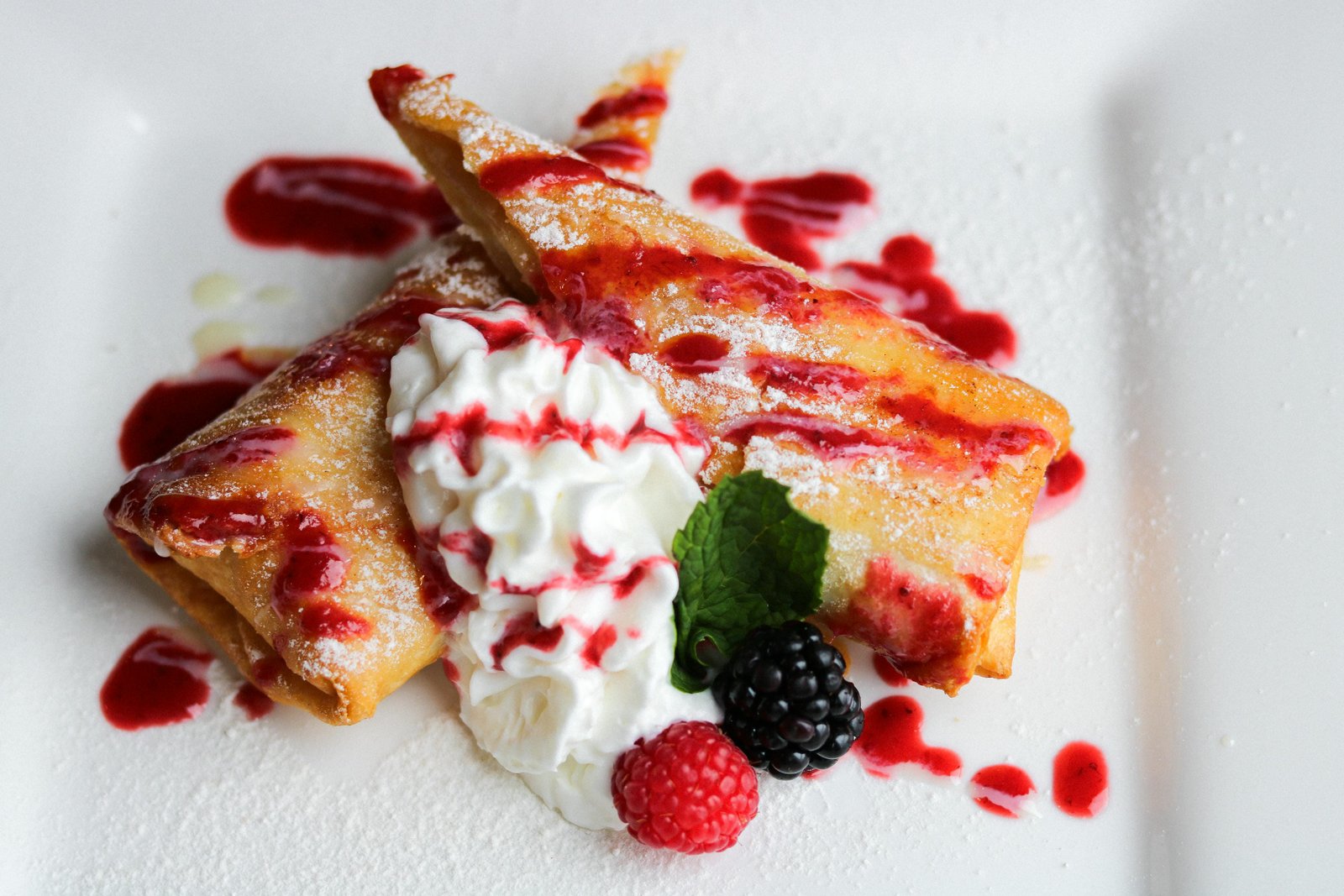 Xangos fried pastry with berry sauce, whipped cream, raspberry and blackberry at Tequila Fuego