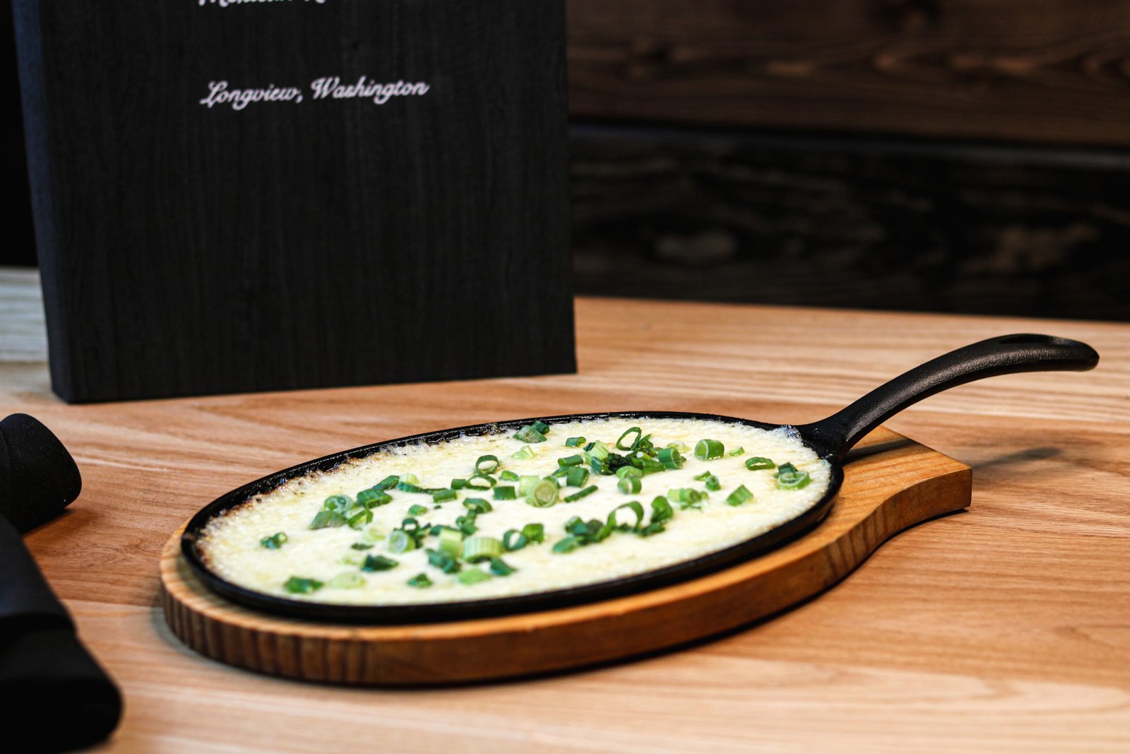 Queso fundido in a small skillet with melted cheese and green onions; chorizo optional, Tequila Fuego happy hour Longview WA.