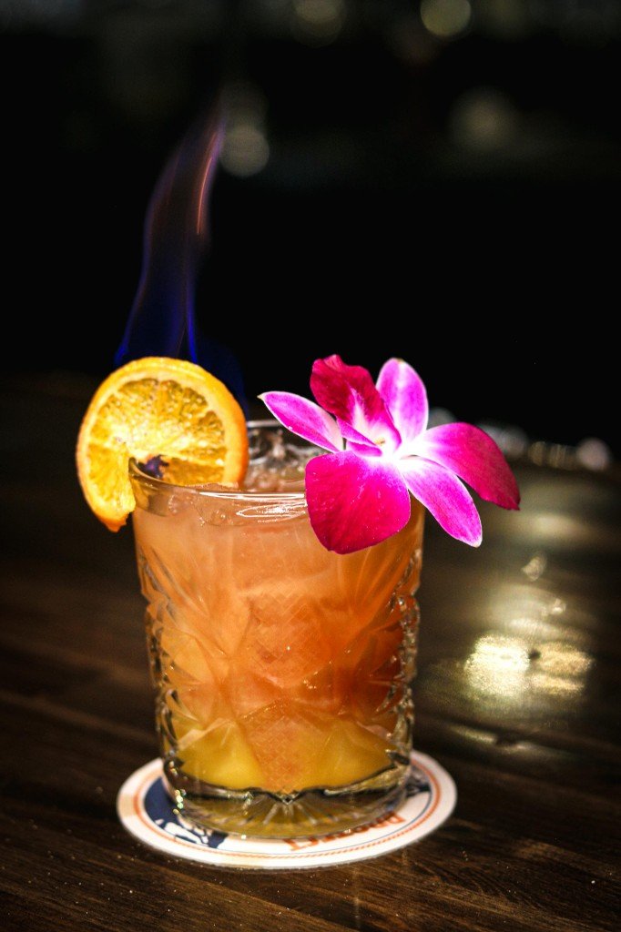 Signature cocktail with flaming orange and orchid at Tequila Fuego Mexican restaurant Longview